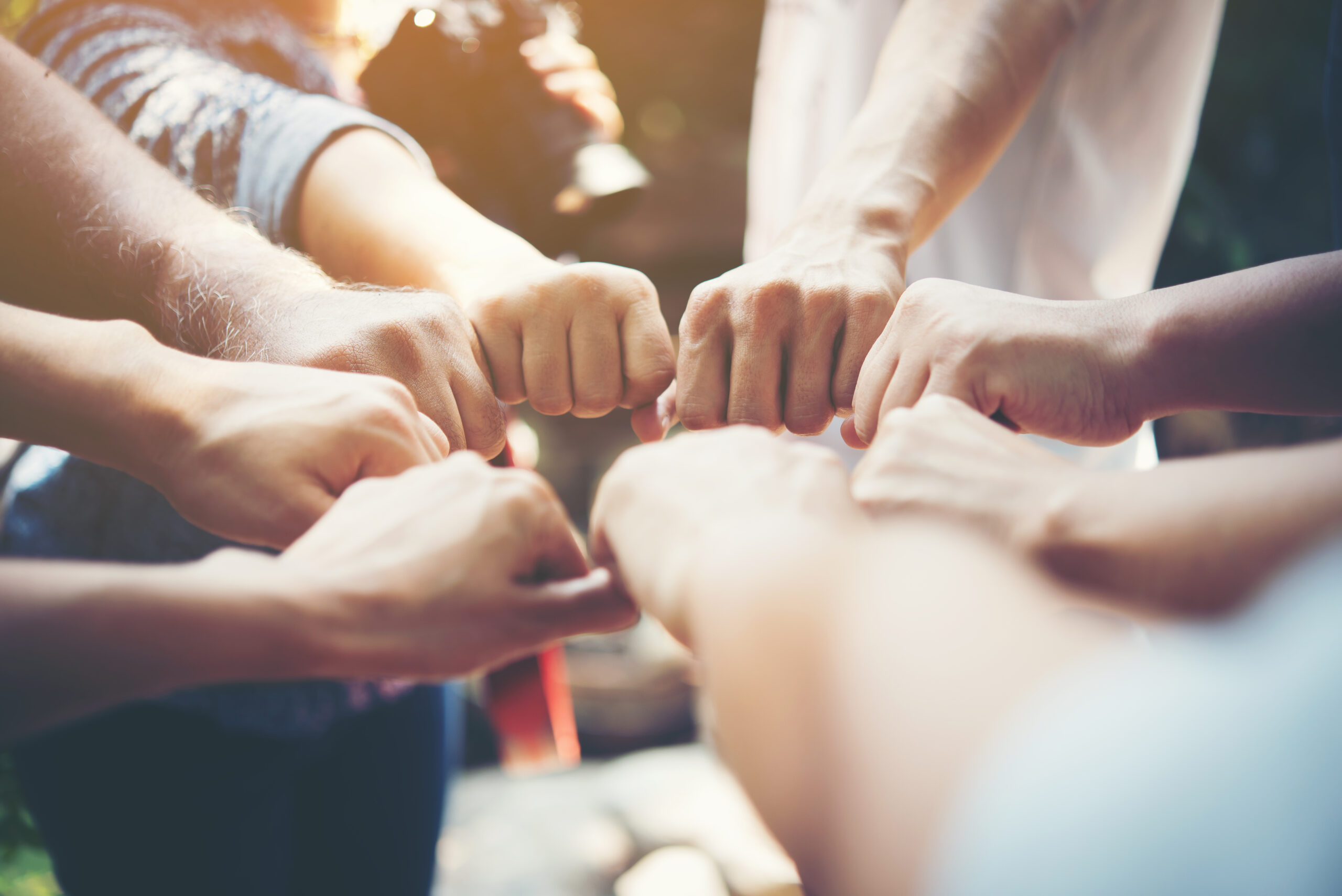 Close up of young people putting their hands together. Team with événement team building