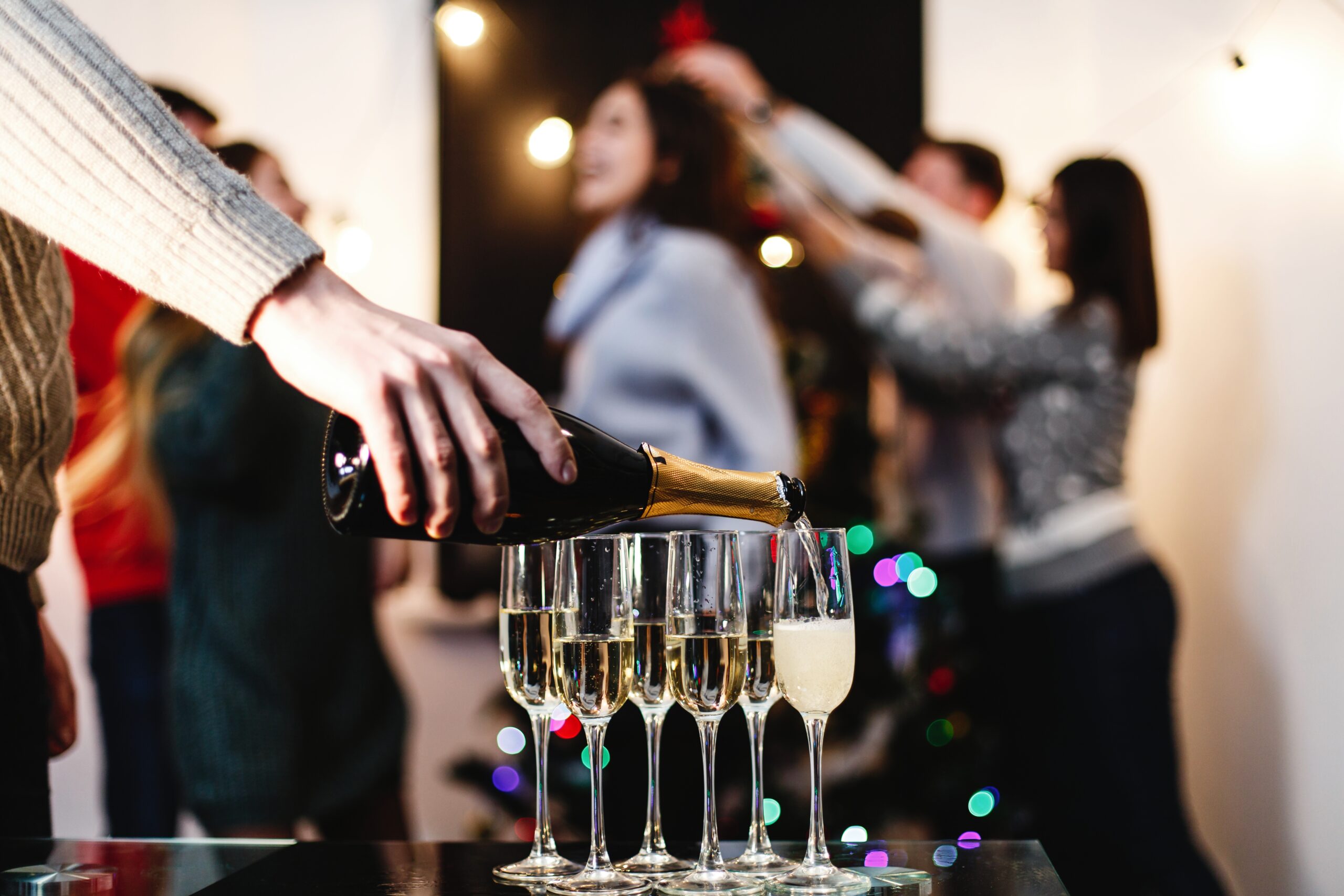 Christmas and New Year preparetions. Company of attractive happy champagne événement